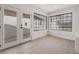 Bright room with modern flooring, large windows, and access to the backyard at 2958 Al De La St, Las Vegas, NV 89146