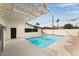 Beautiful backyard featuring an inviting pool with a white pergola and desert landscaping at 2958 Al De La St, Las Vegas, NV 89146