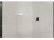The walk-in shower features sleek white subway tiles and black hardware at 2958 Al De La St, Las Vegas, NV 89146