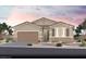 Charming single-story home featuring desert landscaping, a two-car garage, and a welcoming entrance at 3044 Dagny St # Lot 7, Las Vegas, NV 89121