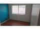 Bedroom featuring wood-look floors, neutral paint, a bright window and a sliding door closet at 3115 Floral Vista Ave, Henderson, NV 89014