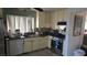 Galley kitchen features bright white cabinets, a stainless steel stove and dishwasher plus a double basin sink at 3115 Floral Vista Ave, Henderson, NV 89014