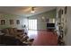 Spacious living room with vaulted ceiling, wood-look floors, a sliding glass door to the back and neutral paint at 3115 Floral Vista Ave, Henderson, NV 89014