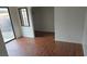 A spacious room with wood-look floors, a large window to an outdoor view, and an entrance to a closet space at 3115 Floral Vista Ave, Henderson, NV 89014