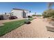 Large backyard showcasing the expansive desert landscaping, synthetic turf, and recreational spaces at 3169 Crystal Moon Rd, Henderson, NV 89052
