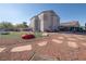 Spacious backyard includes an area of synthetic grass, stone landscaping, and a patio with outdoor seating at 3169 Crystal Moon Rd, Henderson, NV 89052