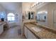 Bright bathroom featuring double sinks, granite countertops, a soaking tub, and lots of natural light at 3169 Crystal Moon Rd, Henderson, NV 89052