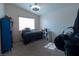 Comfortable bedroom with carpet and a ceiling fan, showcasing natural light from the window at 3169 Crystal Moon Rd, Henderson, NV 89052