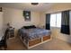 Comfortable bedroom with storage bed, neutral tones, large window with ample sunlight, and ceiling fan at 3169 Crystal Moon Rd, Henderson, NV 89052