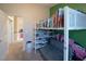 Bedroom featuring a loft bed with built-in storage shelves and a gray futon sofa at 3169 Crystal Moon Rd, Henderson, NV 89052