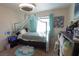Cozy bedroom featuring a canopy bed with soft, neutral tones and ample natural light at 3169 Crystal Moon Rd, Henderson, NV 89052