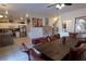 Open-concept dining area with wood table, comfortable seating, view to the kitchen, and stylish decor at 3169 Crystal Moon Rd, Henderson, NV 89052