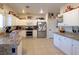 Bright kitchen featuring white cabinets, granite countertops, stainless steel appliances and tiled floors at 3169 Crystal Moon Rd, Henderson, NV 89052
