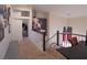 Upstairs landing featuring neutral carpet, with views into the living room, and a staircase to the second floor at 3169 Crystal Moon Rd, Henderson, NV 89052