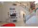Bright living room showcasing the staircase, high ceilings, and stylish décor, with a view into the kitchen at 3169 Crystal Moon Rd, Henderson, NV 89052