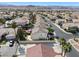 Overhead perspective of a neighborhood displaying well-maintained homes and tree-lined streets against a mountain backdrop at 319 Fox Lake Ave, Las Vegas, NV 89148