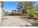 The backyard features a gravel landscape, concrete patio and mature trees at 319 Fox Lake Ave, Las Vegas, NV 89148
