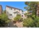 This backyard features a gravel landscape, mature trees, and a covered patio at 319 Fox Lake Ave, Las Vegas, NV 89148