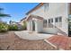 The backyard features gravel landscape, mature trees, and a concrete patio at 319 Fox Lake Ave, Las Vegas, NV 89148