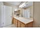 Bright bathroom featuring a spacious vanity with a white countertop and modern lighting fixtures at 319 Fox Lake Ave, Las Vegas, NV 89148