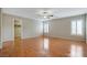 Spacious bedroom features wood floors, ceiling fan, and bright, shuttered windows at 319 Fox Lake Ave, Las Vegas, NV 89148