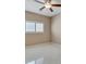 Bedroom showcasing tile flooring, a ceiling fan, and a window with plantation shutters at 319 Fox Lake Ave, Las Vegas, NV 89148