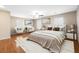 Bright, airy bedroom featuring hardwood floors, neutral walls, ceiling fan and sitting area at 319 Fox Lake Ave, Las Vegas, NV 89148