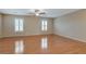 Bright primary bedroom boasts wood floors and two bright, shuttered windows at 319 Fox Lake Ave, Las Vegas, NV 89148
