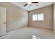 Bright bedroom featuring tile flooring, a ceiling fan, and a window with plantation shutters at 319 Fox Lake Ave, Las Vegas, NV 89148