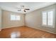 Bedroom with hardwood flooring, a ceiling fan, and plantation shutters at 319 Fox Lake Ave, Las Vegas, NV 89148