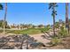 Beautiful golf course view featuring lush green fairways, sandy bunkers, and mature palm trees against a clear blue sky at 319 Fox Lake Ave, Las Vegas, NV 89148