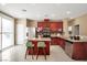 Eat-in kitchen featuring stainless steel appliances, granite countertops, and cherry wood cabinets at 319 Fox Lake Ave, Las Vegas, NV 89148