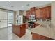 Updated kitchen with granite countertops, a center island, and stainless-steel appliances at 319 Fox Lake Ave, Las Vegas, NV 89148