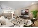 Spacious open-plan living room with modern decor, tile flooring, and large windows for plenty of light at 319 Fox Lake Ave, Las Vegas, NV 89148