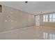 Neutral living space offers ceramic flooring, neutral paint, and is lit with natural light at 319 Fox Lake Ave, Las Vegas, NV 89148