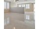 Bright living room features neutral colors, modern tile flooring, and ample natural light through the windows at 319 Fox Lake Ave, Las Vegas, NV 89148
