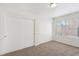 Neutral bedroom with dual closets, carpeted floors, and a bright window at 3225 Casey Dr # 203, Las Vegas, NV 89120