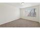 Neutral bedroom with carpeted floors and a bright window with blinds at 3225 Casey Dr # 203, Las Vegas, NV 89120