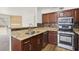 Updated kitchen featuring stainless appliances, granite countertops, and wood cabinets at 3225 Casey Dr # 203, Las Vegas, NV 89120