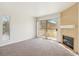 Bright living room with a fireplace and sliding glass door to the outdoor patio at 3225 Casey Dr # 203, Las Vegas, NV 89120