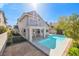 Back exterior with a beautiful swimming pool, complemented by a small deck and balcony above at 3329 Buffalo Narrows Cir, Las Vegas, NV 89129