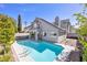 A beautifully landscaped backyard with a private pool and well-maintained patio at 3329 Buffalo Narrows Cir, Las Vegas, NV 89129