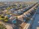 Expansive aerial view of homes in a desert community, featuring mature landscaping and a community pool at 3439 Cottage Canyon St, Laughlin, NV 89029