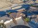 Aerial view of the home showing the roof, driveway, desert landscaping and backyard pool at 3439 Cottage Canyon St, Laughlin, NV 89029