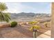 Desert landscaped backyard with a fountain and views of the mountains at 3439 Cottage Canyon St, Laughlin, NV 89029