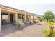 Relaxing backyard with desert landscaping, a covered patio, and charming water feature at 3439 Cottage Canyon St, Laughlin, NV 89029