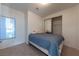 Bedroom featuring neutral carpet, a window for natural light, and mirrored closet doors at 3439 Cottage Canyon St, Laughlin, NV 89029