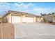 Wide angle shot of the home, highlighting the three car garage and long driveway at 3439 Cottage Canyon St, Laughlin, NV 89029