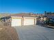 Beautiful shot showcasing a three car garage, desert landscaping and extra long driveway at 3439 Cottage Canyon St, Laughlin, NV 89029