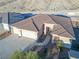 Aerial view of a three-car garage home with desert landscaping and a brown roof at 3439 Cottage Canyon St, Laughlin, NV 89029